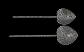 A Pair of Persian Silver Spoons profusely decorated with floral detail throughout. Approximately