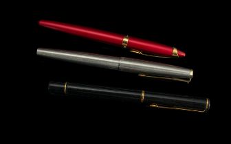 Three Fountain Pens, comprising a silver tone Parker pen with a 14 carat gold nib, black and gold
