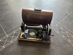 Vintage Singer Sewing Machine, black with gilt decoration, registration No. EC101627. Housed in