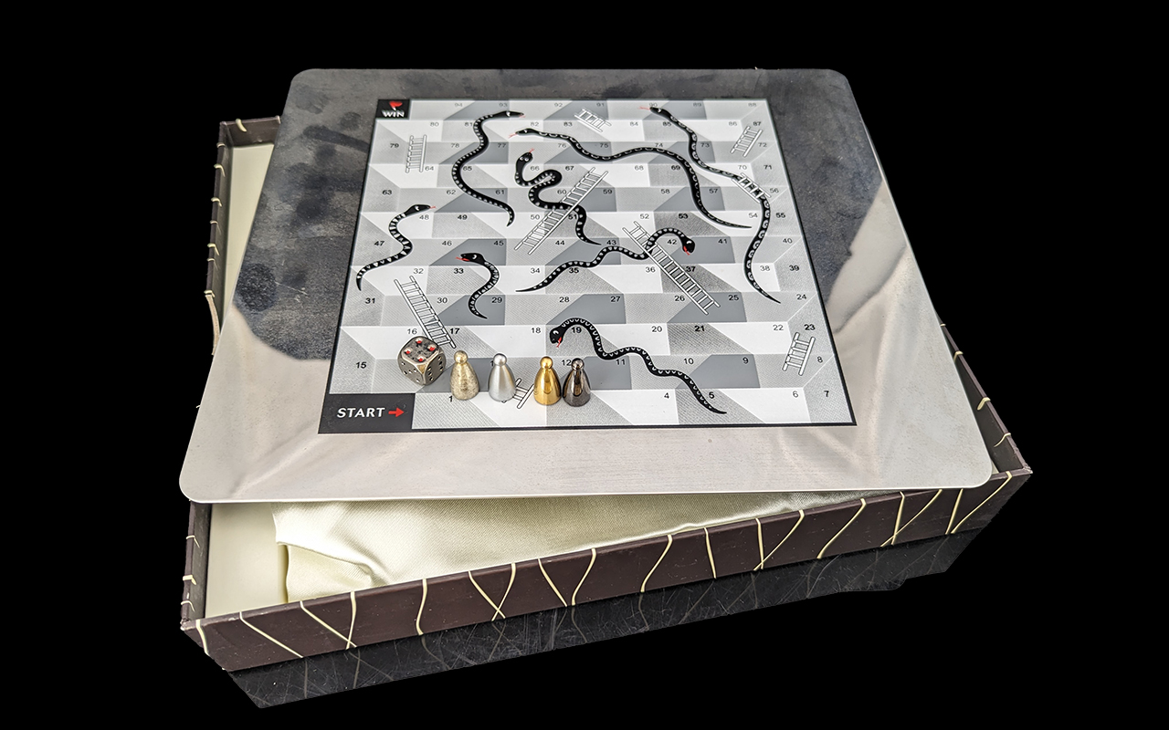 Arthur Price Boxed Decorative Metal Snakes & Ladders Set, boxed, with dice and markers.