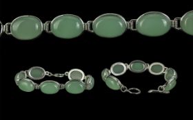 Jade Bracelet, seven oval jade stones set in white metal.