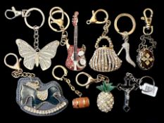 A Collection of Assorted Novelty Key Rings. Designs include handbags, a guitar, butterfly, a cross