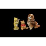 Three Disney Figures, comprising Beswick Winnie the Pooh, Royal Doulton Pooh and Piglet, and