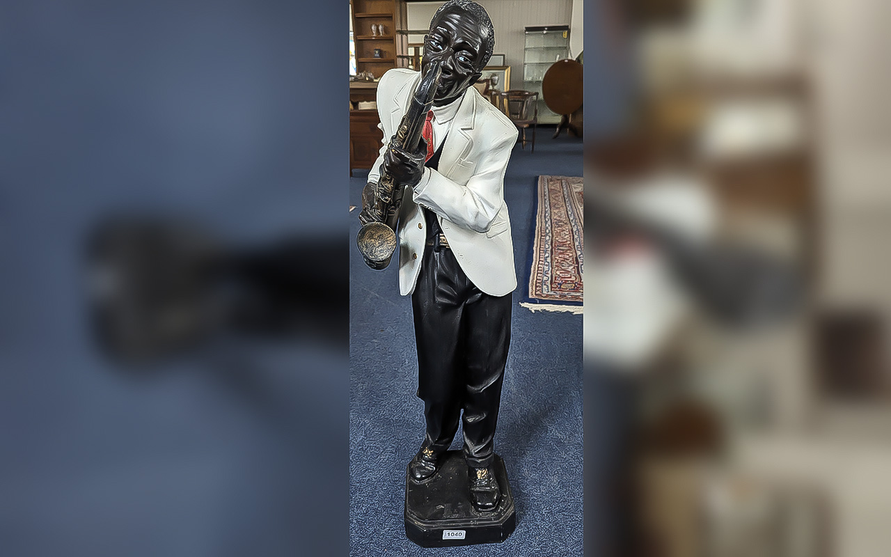 Wooden Saxophone Player Statue, wearing a white dinner jacket and red tie. Approx. 34'' high.