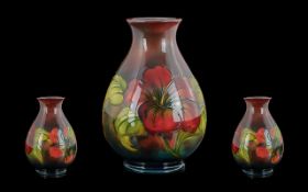 Moorcroft Pleasing Early Version Tubelined Flambe Ovoid Vase, 'Hibiscus' design in reds and