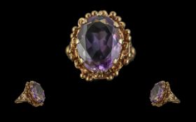 9ct Gold - Attractive Single Stone Amethyst Set Ring, Ornate Setting. Marked 9ct to Shank. The Large