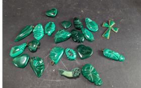 A Collection of Malachite Pendants and Carvings, including a cross, tribal masks, heart shaped, etc.