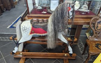 An Antique Rocking Horse fully restored. Dappled grey in colour with added leather saddle. 46 inches