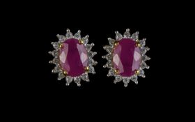 Ruby Halo Stud Earrings, each of the two oval cut, rich red, rubies of 1.5cts, framed with a halo of