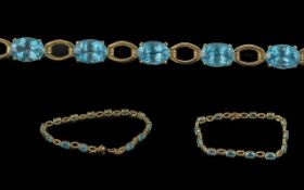 Ladies 14ct Gold Blue Topaz Set Line Bracelet. Marked 14ct. The Blue Topaz are Well Matched and