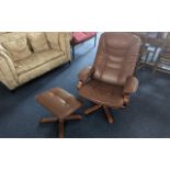 A Brown Leather Swivel Chair with matching foot rest. Measures 40 inches high by 30 inches deep.