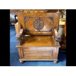 Early 20th Century Oak Monk's Bench with fold over back rest, lion carved arm rests, hinged seat and