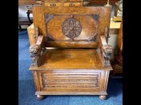 Early 20th Century Oak Monk's Bench with fold over back rest, lion carved arm rests, hinged seat and