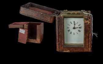 A Brass Carriage Clock, typical form, white dial, Arabic numerals, with case and further empty