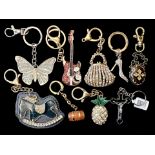 A Collection of Assorted Novelty Key Rings. Designs include handbags, a guitar, butterfly, a cross