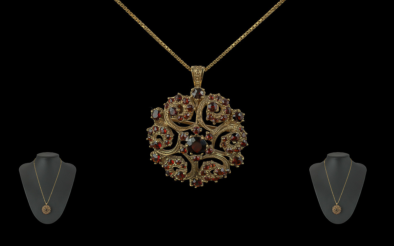 Ladies 9ct Gold Garnet Set Open Worked Pendant / Brooch of Circular Form, Attached to a 9ct Gold