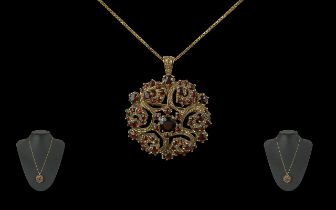 Ladies 9ct Gold Garnet Set Open Worked Pendant / Brooch of Circular Form, Attached to a 9ct Gold