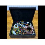Box of Costume Jewellery, comprising assorted coloured beads, bracelets, etc., housed in a black