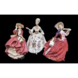 Three Royal Doulton Figurines, comprising 'Top of the Hill', HN1834, 'Autumn Breezes' HN1934, and '