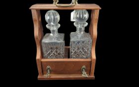 Tantalus With Two Decanters, keys to lock front. Height 13'' x width 10'' x depth 6''.