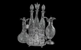 Four Pieces of Silver Plated Ware including a cruet set and stand, two silver plated claret jugs,
