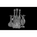 Four Pieces of Silver Plated Ware including a cruet set and stand, two silver plated claret jugs,