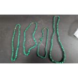 Four Strings of Malachite Beads, 3 x 20'' length and 1 x 28''.