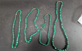 Four Strings of Malachite Beads, 3 x 20'' length and 1 x 28''.