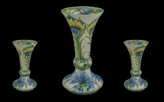 William Moorcroft Dated Tube lined Cornflower Blue and Yellow Daisy Vase with bulbous lower and