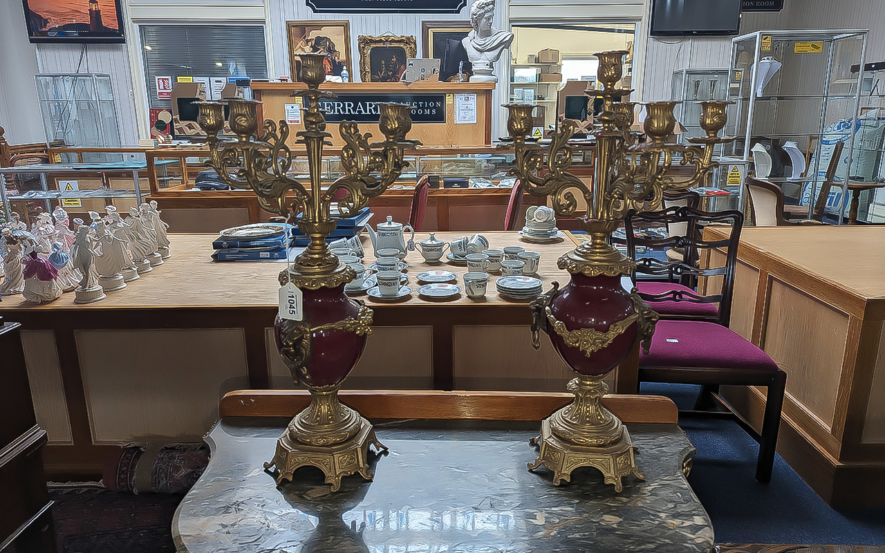 A Pair of Brass & Red Six Branch Candelabra, stand at 21'' high, a brass ornate base with a red