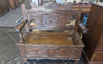 Early 20th Century Oak Monk's Bench, two seater, typical form, carved panels throughout, hinged