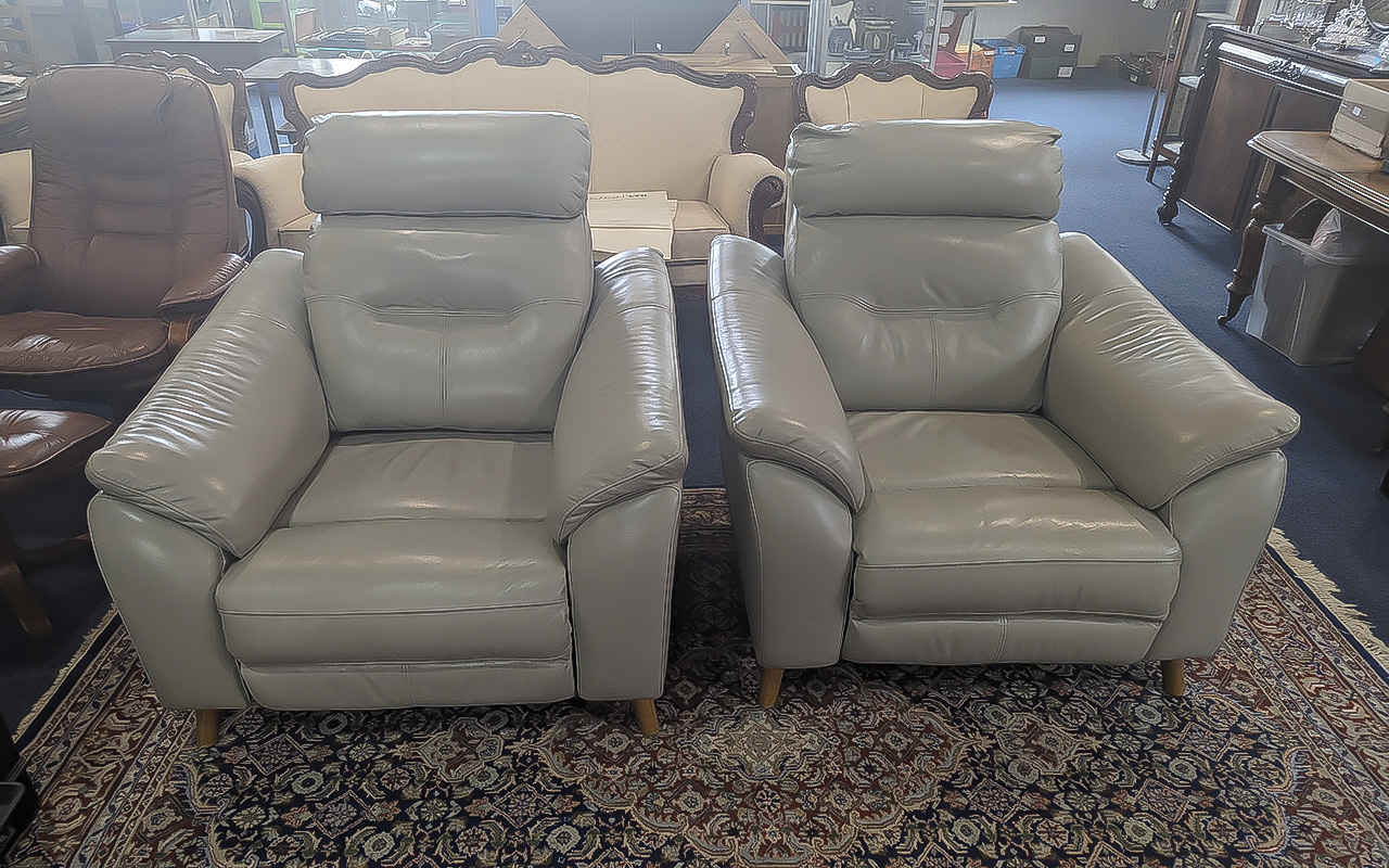 Two Electric Reclining Chairs, grey leather armchairs.