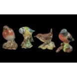 Four Beswick Birds, comprising Robin 980, Blue Tit 992, Wren 993, and Chaffinch 991.