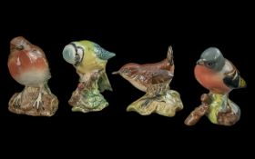 Four Beswick Birds, comprising Robin 980, Blue Tit 992, Wren 993, and Chaffinch 991.