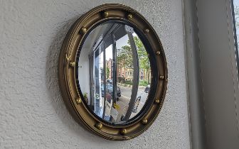 Mid Century Concave Mirror with baubles for decoration, approx. 17'' x 17''.