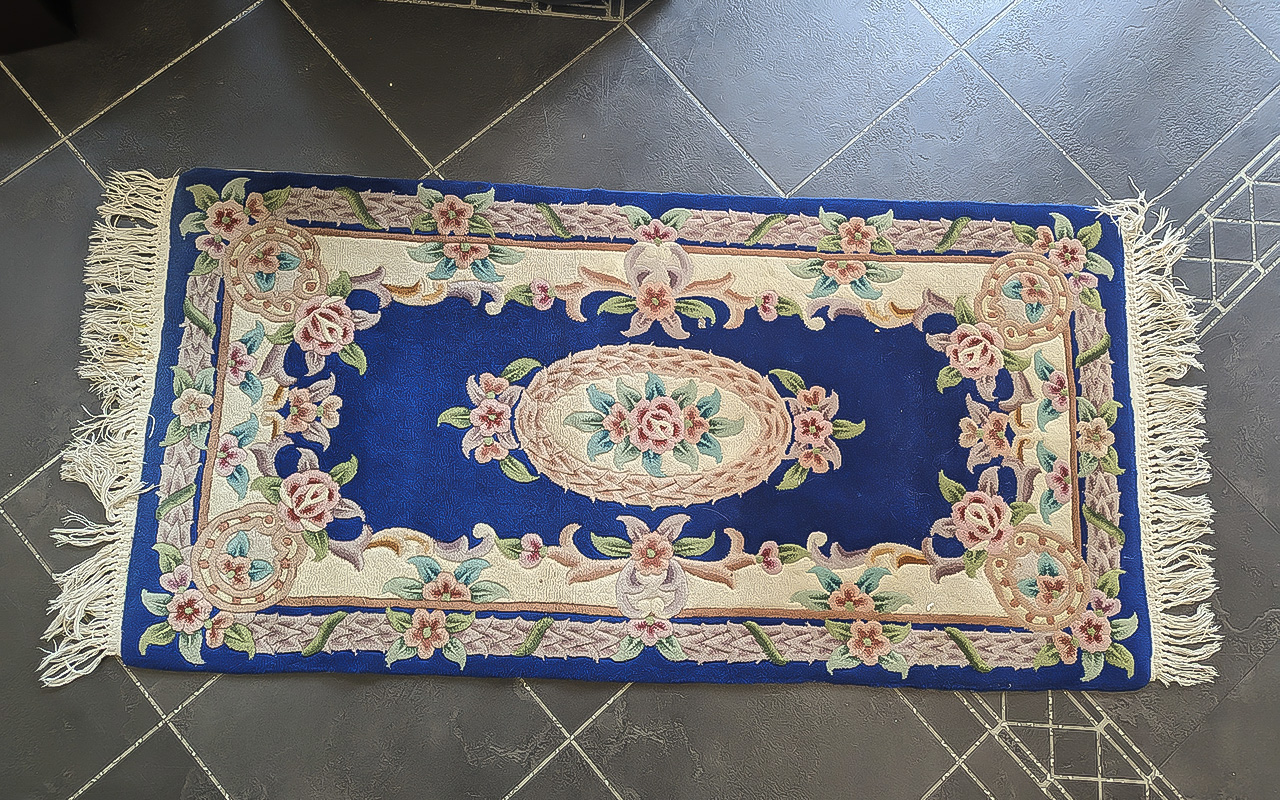 Chinese Wool Runner, measures 5' x 2.6', dark blue background with floral pattern and fringing. 100%