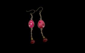 Pair of Drop Earrings, set with an oval pink stone, approx 2'' drop with a small circular bead at
