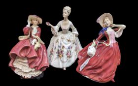 Three Royal Doulton Figurines, comprising 'Top of the Hill', HN1834, 'Autumn Breezes' HN1934, and '