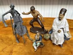 Two Mudmen Figures, one 9.5'' high of a scholar with his books, and a 4'' figure of a man resting on