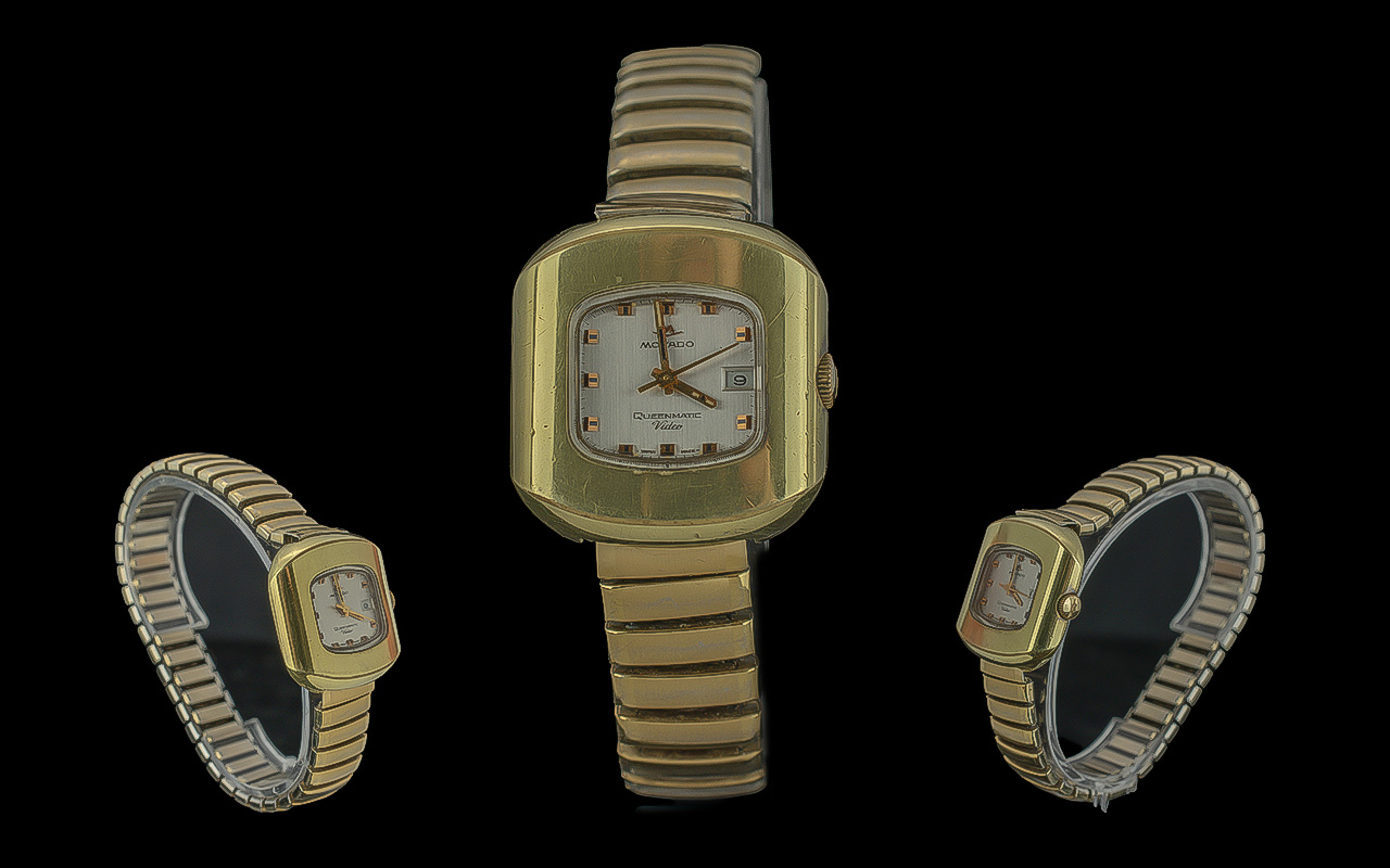 Ladies Movado Queenmatic Video Bracelet Watch, gold tone expanding strap, white face with gold