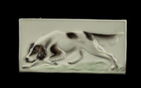 Goldschider hand painted wall plaque depicting a dog on cream ground. goldschider stamp to back of