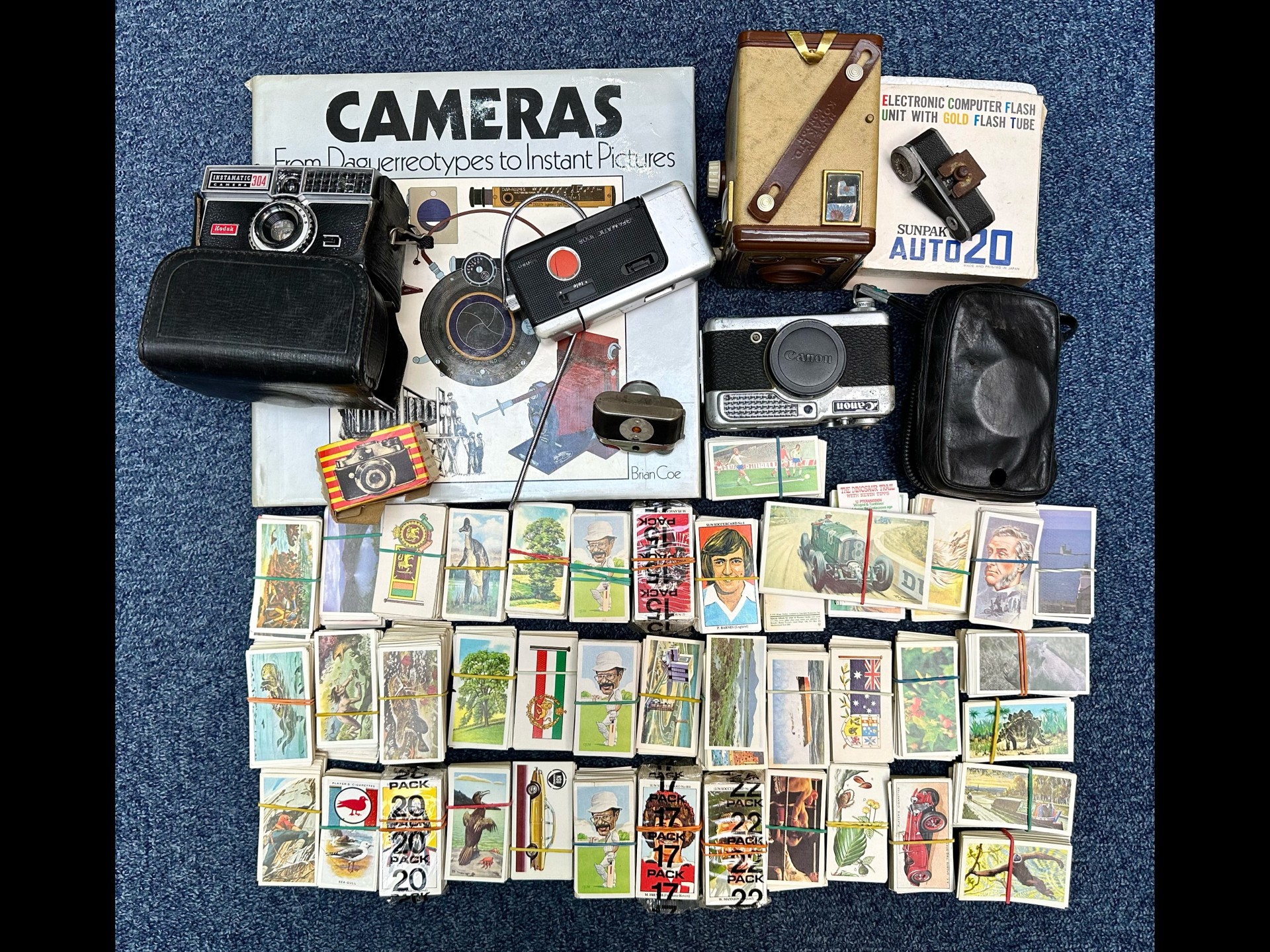 A Collection of Cameras and Cigarette Cards cameras to include Brownie, Kodak, Canon, Polaroid
