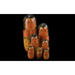 Two Russian Matryoshka Dolls, one measures 9'' and one 3'' high. Hand decorated.