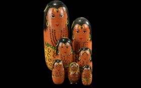 Two Russian Matryoshka Dolls, one measures 9'' and one 3'' high. Hand decorated.