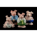 Set of Four Nat West Wade Piggy Banks, including Mother, Baby, School Boy and School Girl.