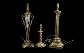 Three Brass Table Lamps, one in the form of a Corinthian column, one in the form of an oil lamp with