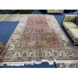 Large Royal Keyshan Wool Carpet, pink background with floral border and fringing, (some marks),