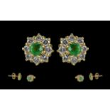 Ladies - pleasing 18ct gold diamond and emerald set pair of earrings. marked 750 - 18ct. the central