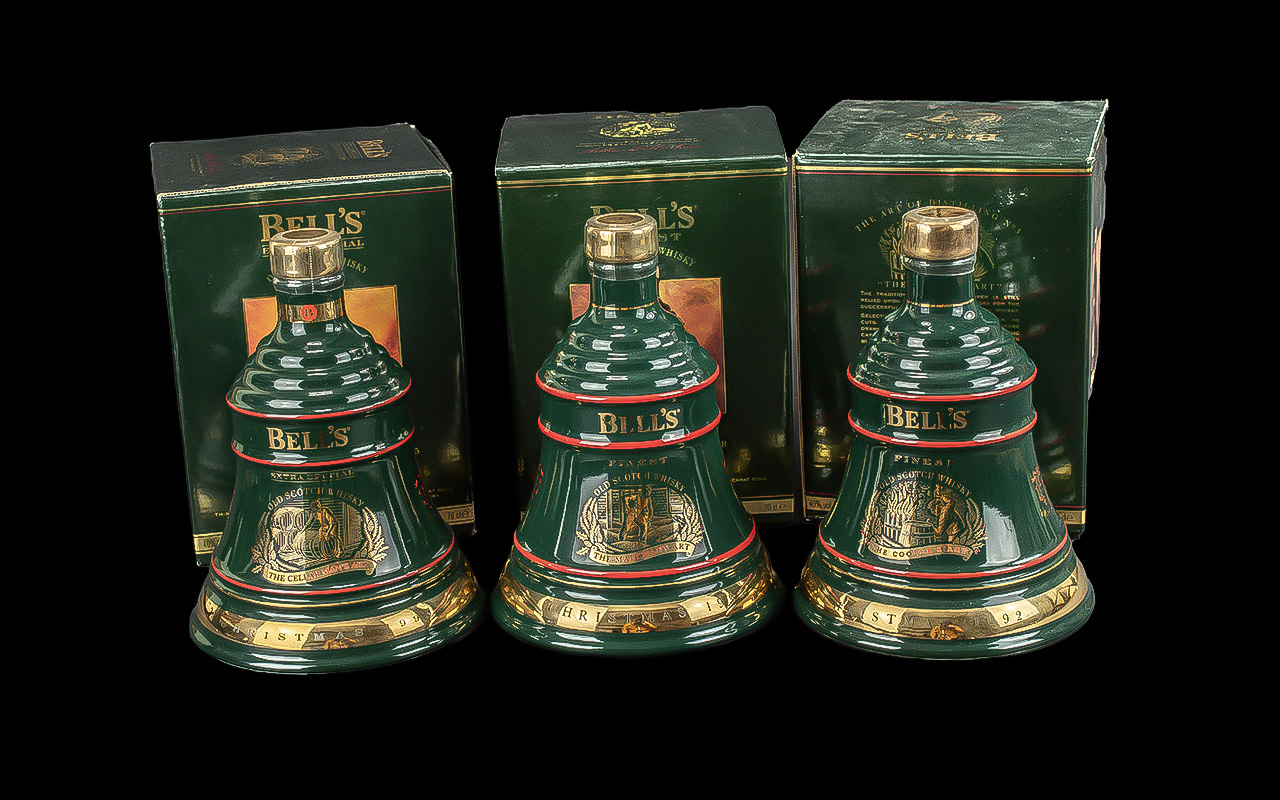 Three Bottles of Bells Old Scotch Whisky Christmas Decanters, full contents, 8 years old, in