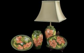 Collection of Moorcroft 'Coral Hibiscus' pattern, comprising a table lamp with shade, a matching